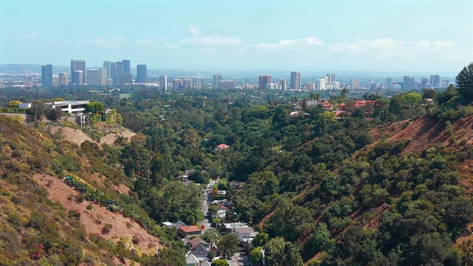 Aerial drone view over the Bel Air hills toward the Century City skyline