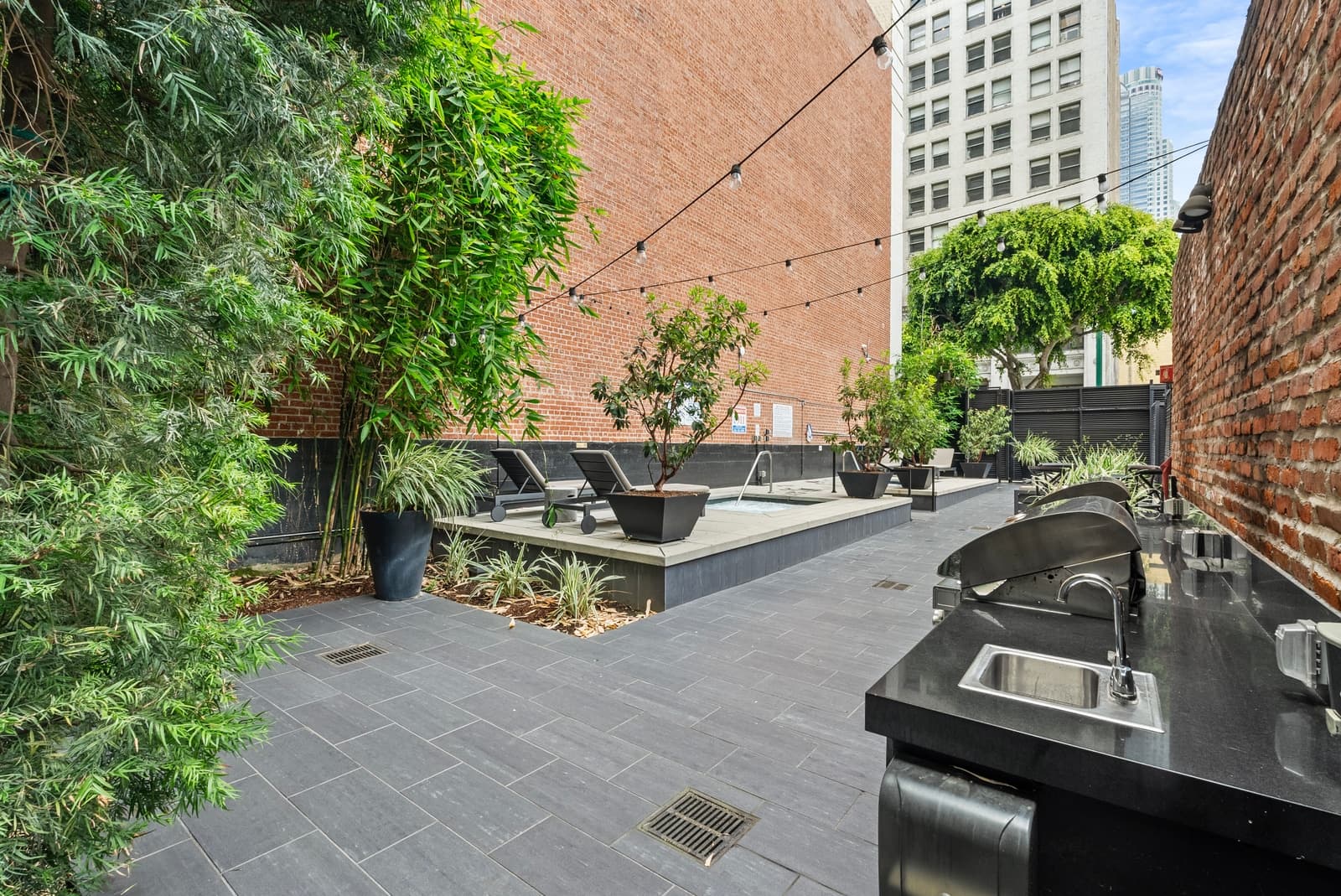 Rooftop amenity deck with the Downtown LA skyline, photographed by VVT