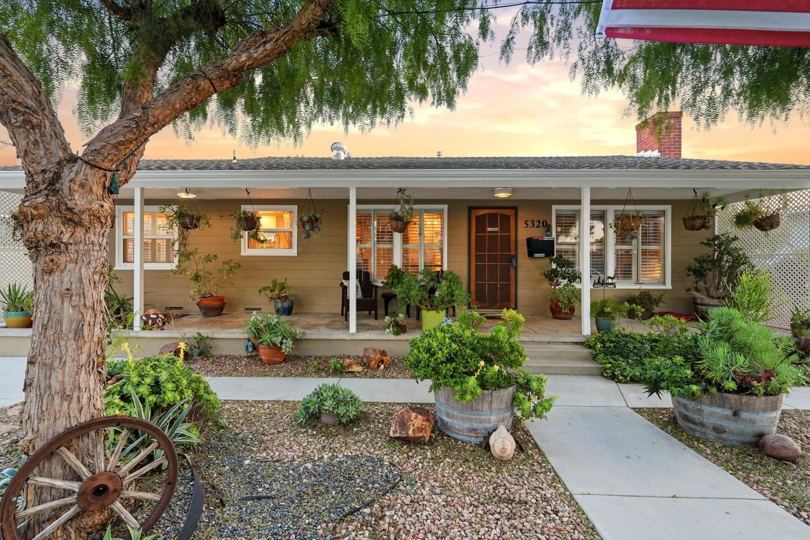 Twilight bungalow with warm porch light on Pavo Street in Long Beach