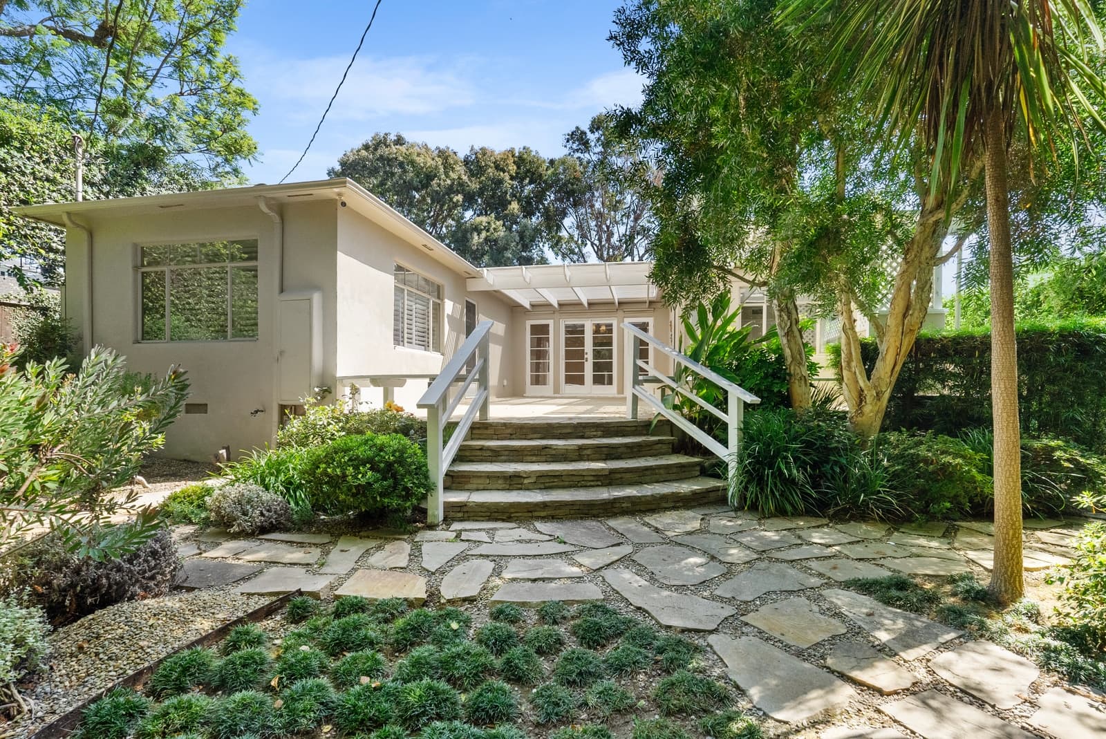 White exterior of a Pacific Palisades listing, photographed by VVT
